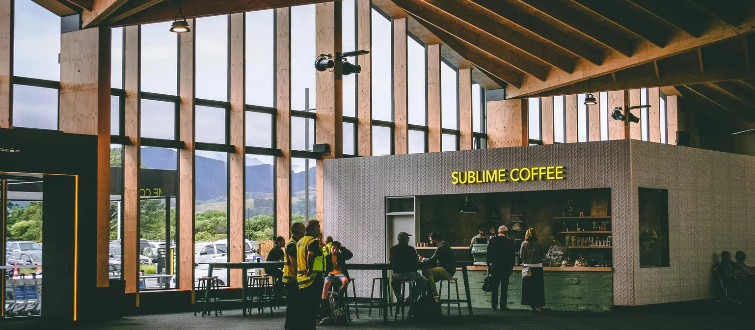 New Zealand coffee shop with customers representing local SEO visibility for small businesses